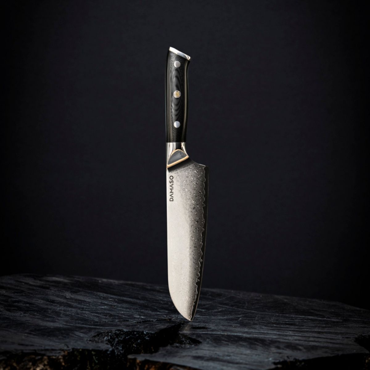 A chef's knife with a textured blade and dark handle on a black background.