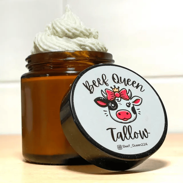 Jar of cream with a cartoon cow on the lid, labeled 'Beef Queen Tallow.'