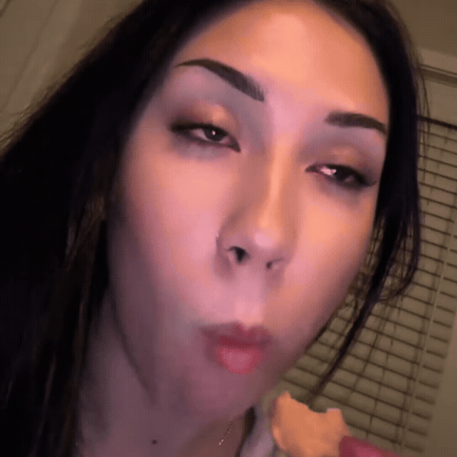 Person eating a cookie with a neutral expression.