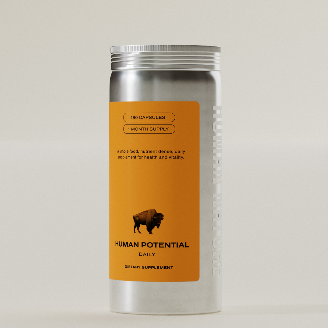 A silver canister of Human Potential dietary supplement with an orange label featuring a bison.