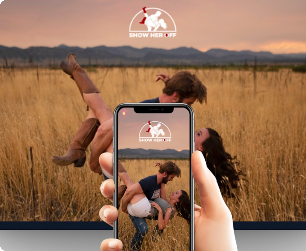 Couple dancing in a field, viewed through a smartphone screen.