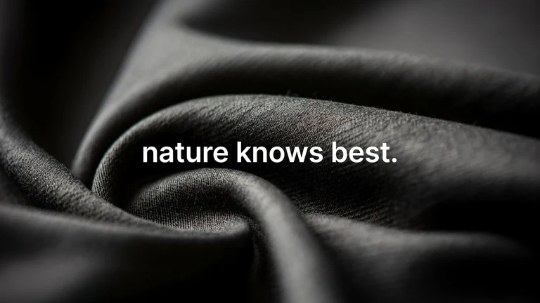 Close-up of black fabric with text 'nature knows best.'