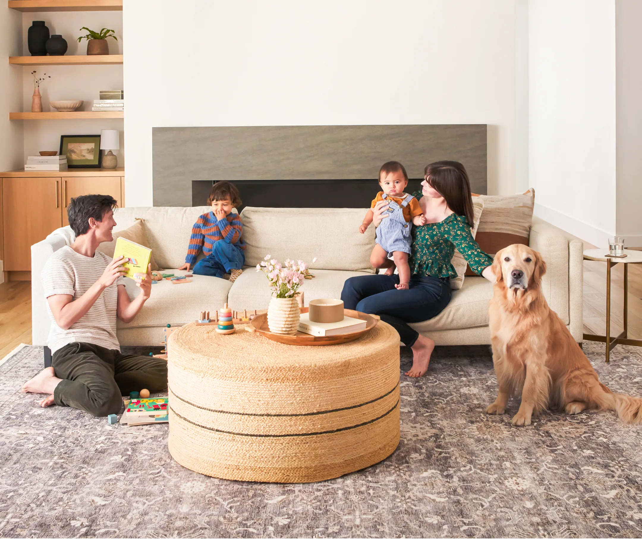 Family playing in a cozy living room with a golden retriever.