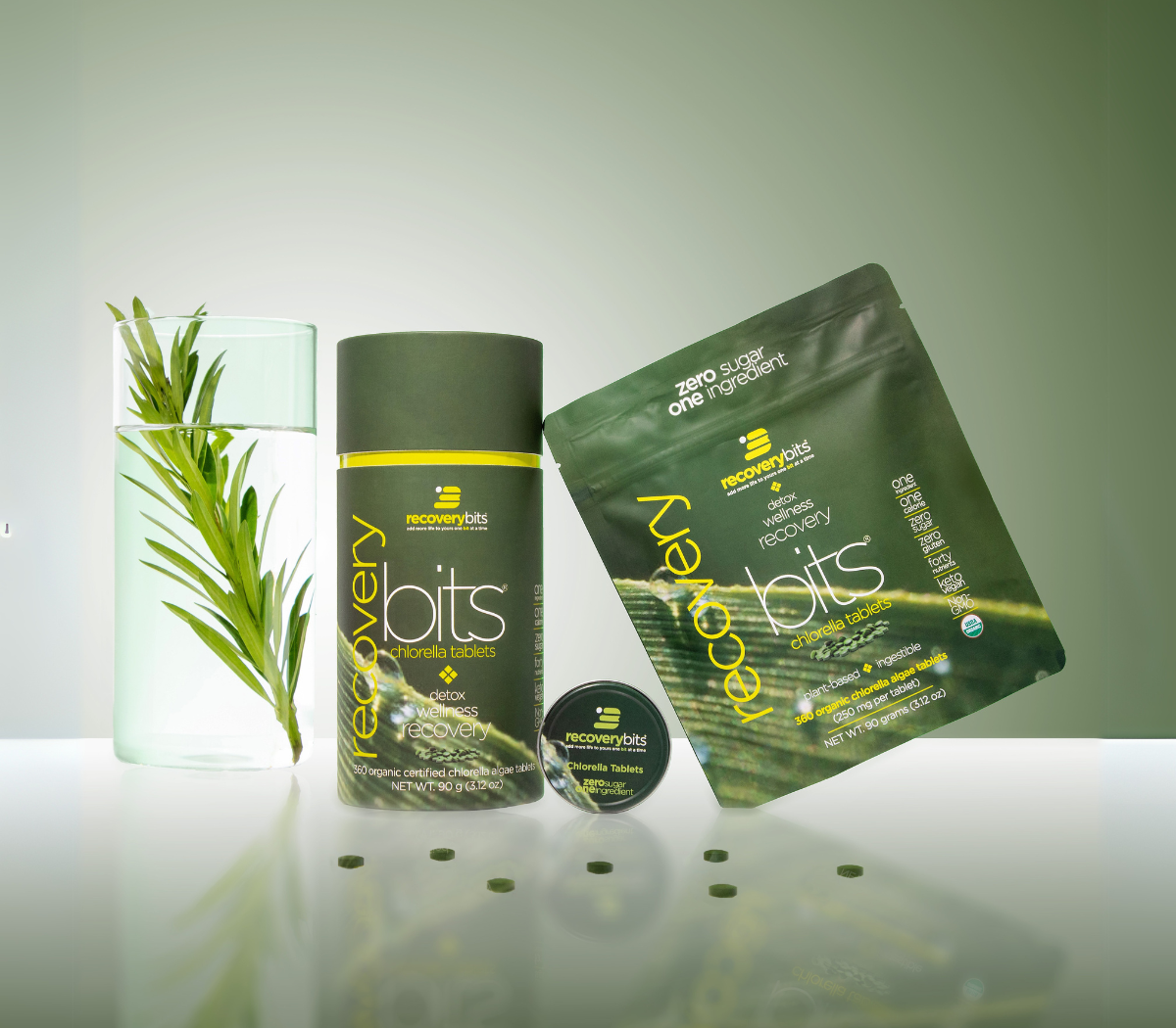 Recovery Bits chlorella tablets packaging with a plant in a glass of water.