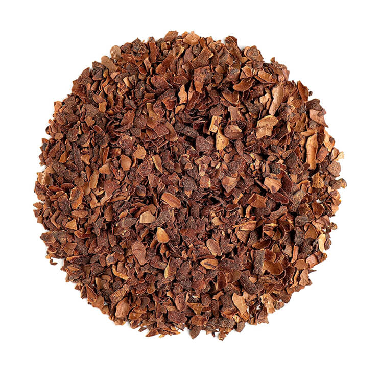 A pile of brown, crushed cacao nibs on a white background.