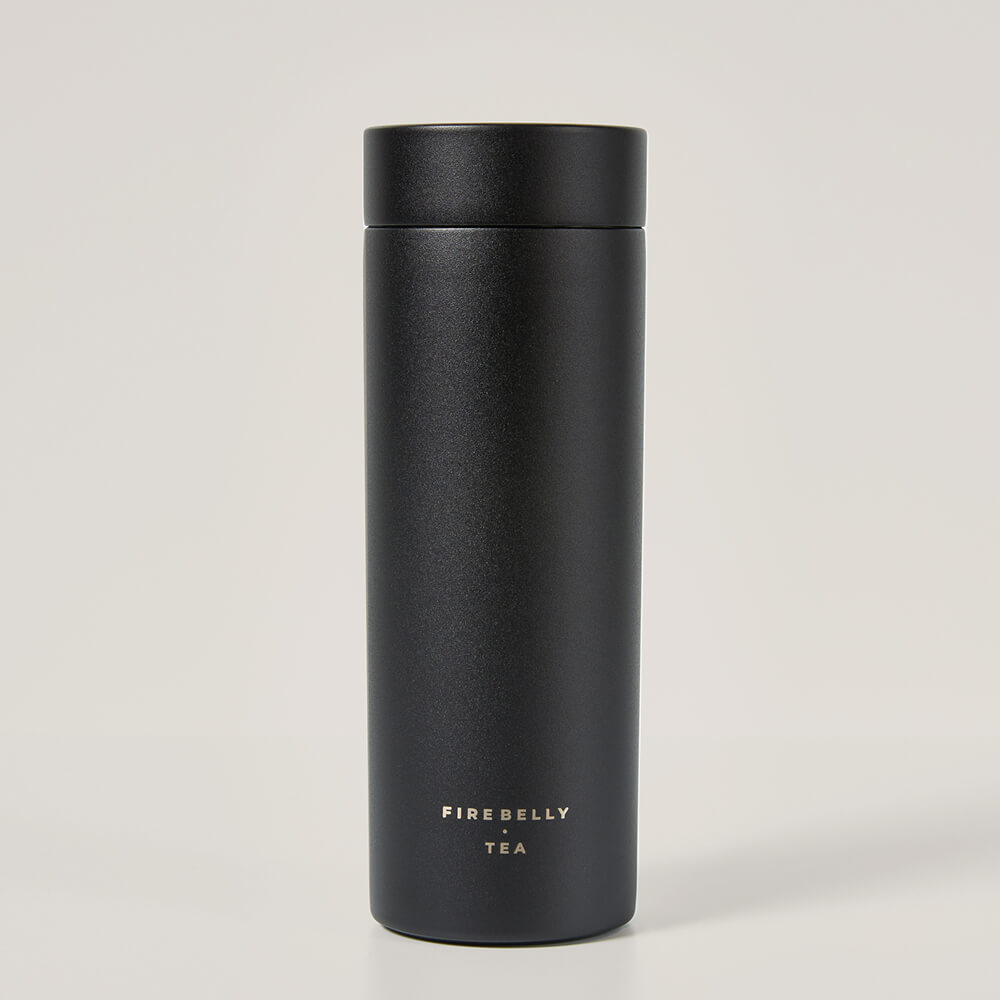 A matte black travel mug with the logo for Fire Belly Tea printed near the bottom.