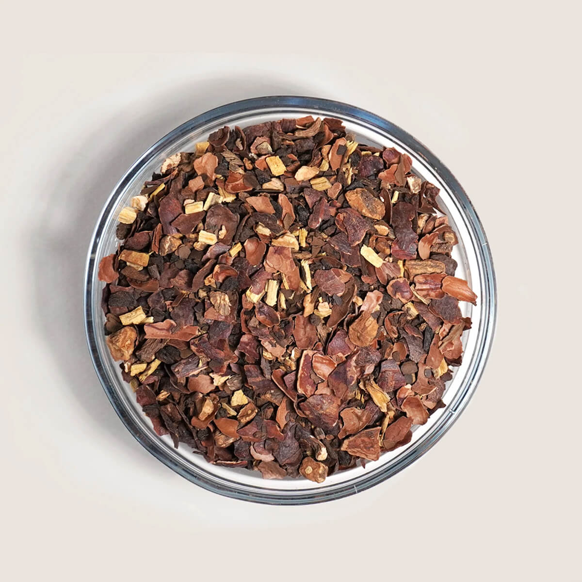 A bowl filled with dried brown and beige plant pieces.
