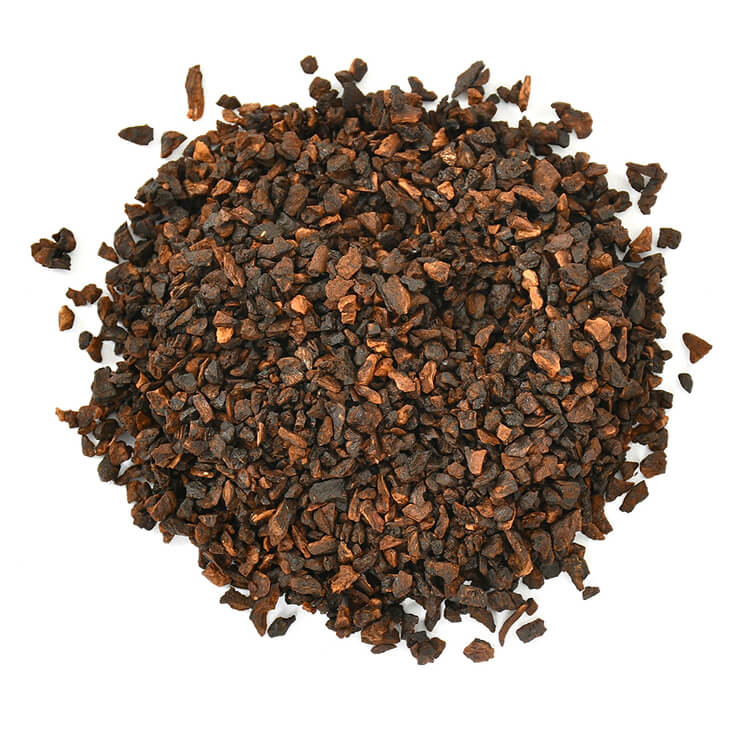 Pile of dark brown granules on a white background.