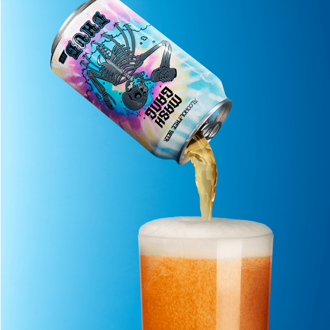 A colorful can pouring beer into a glass with foam on top.