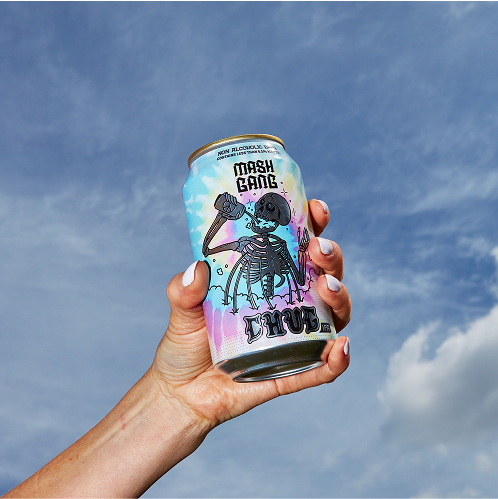 Hand holding a colorful can against a blue sky with clouds.