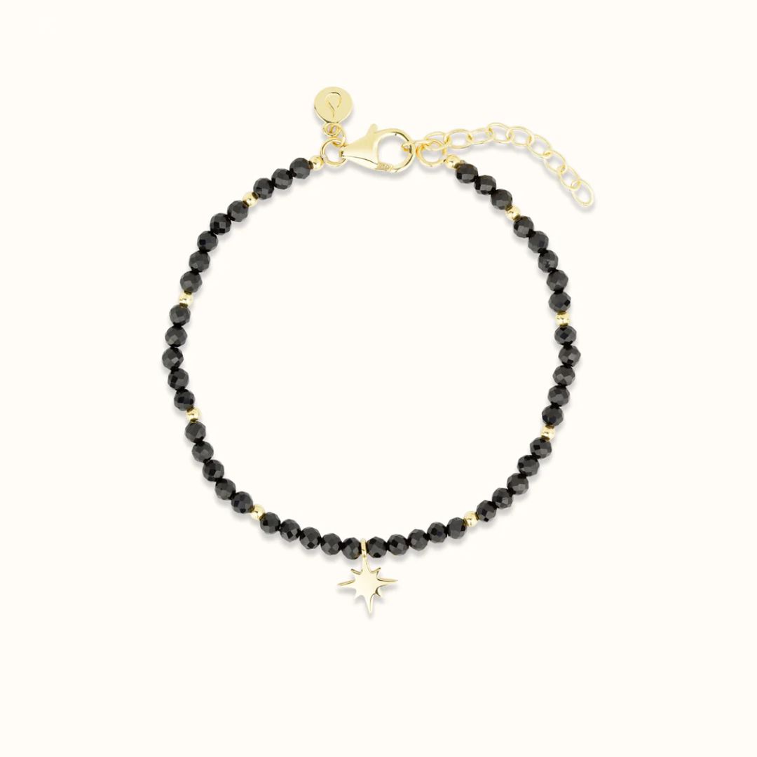 Black beaded bracelet with a star charm and gold clasp.