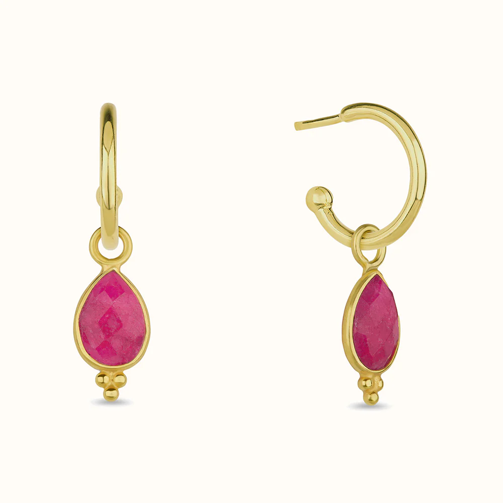 Gold earrings with dangling pink teardrop gemstones.