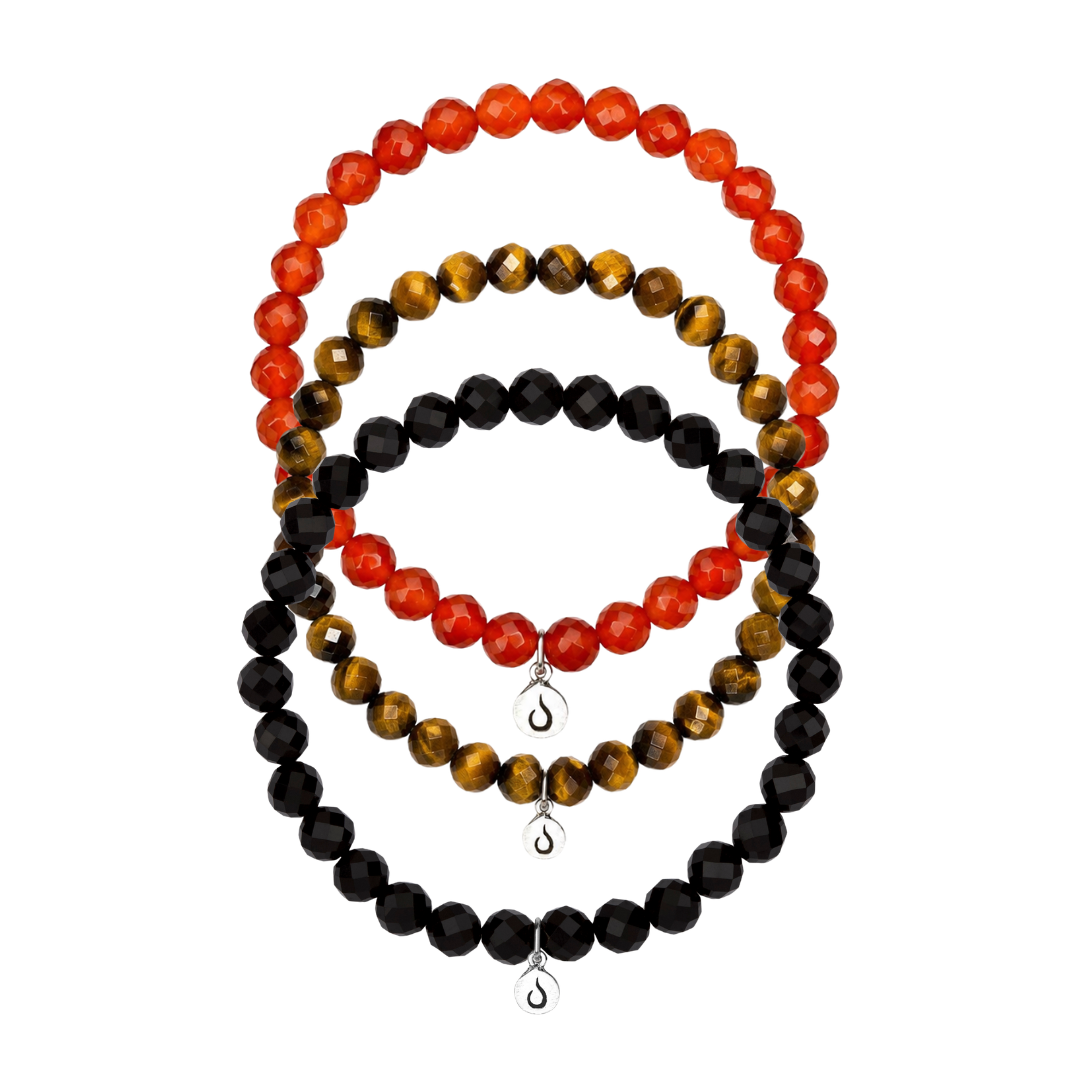 Three bracelets made of faceted beads in red, black, and brown tiger's eye, with small silver charms.