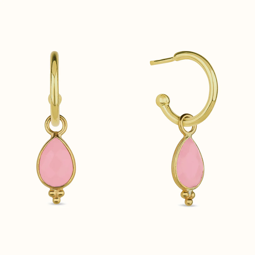 Gold hoop earrings with pink teardrop pendants.