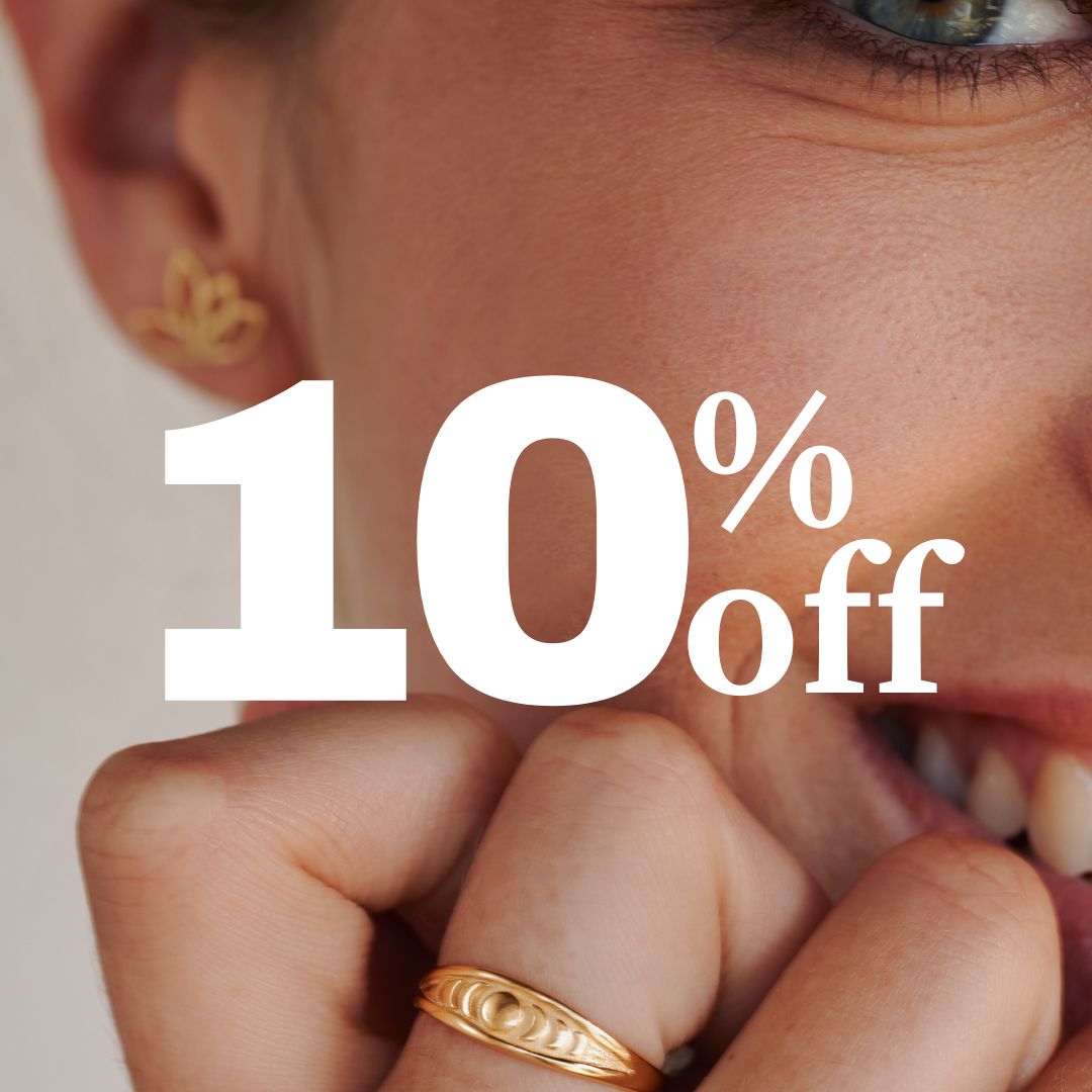A close-up of a woman smiling, wearing gold jewelry, with text that reads '10% off' over the image.