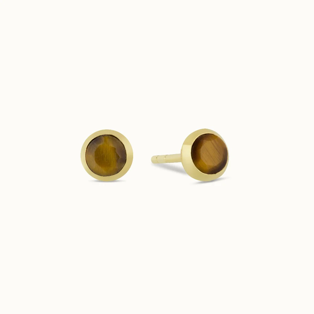 Pair of gold earrings with round brown stones inlay.
