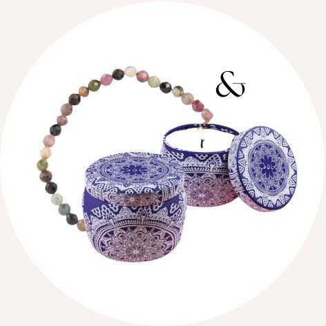Decorative blue and white patterned containers with a beaded bracelet.
