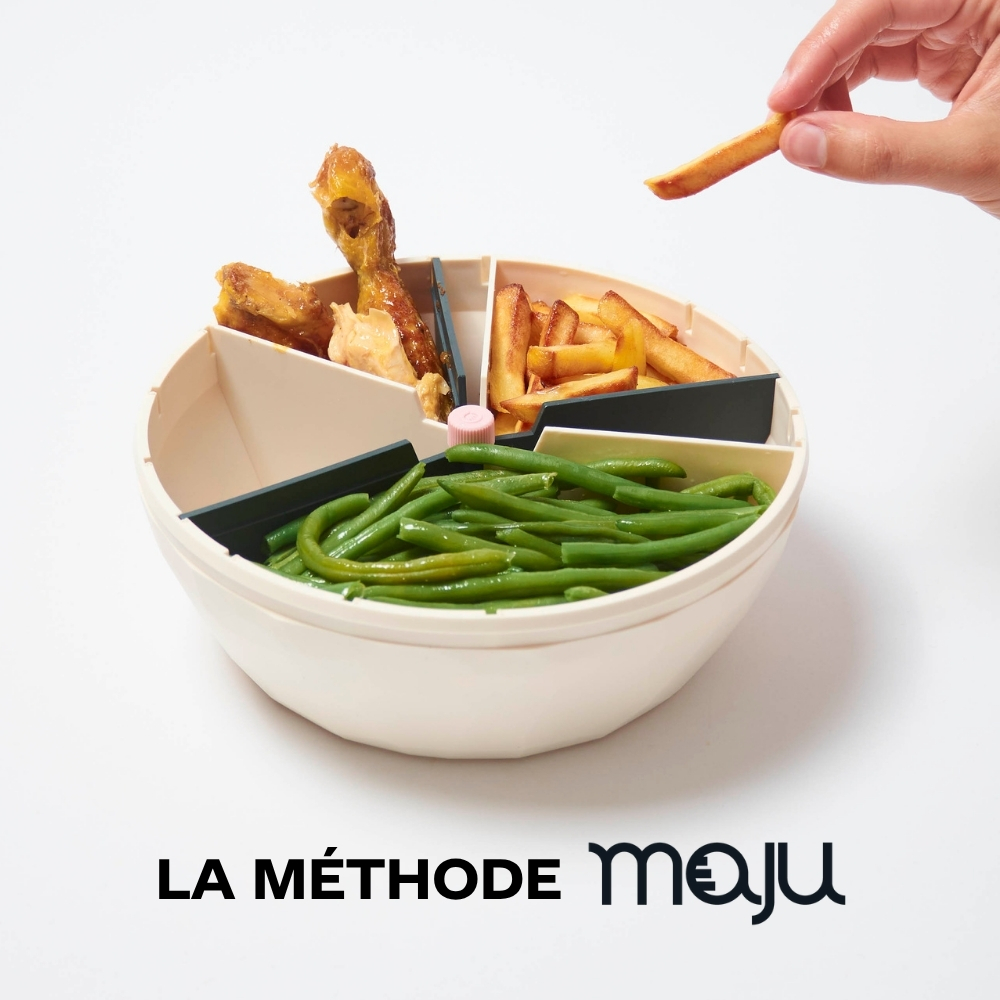A hand takes a french fry from a sectioned bowl containing green beans, fries, and chicken.