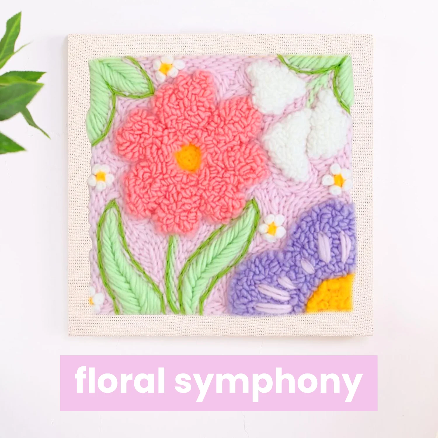 Colorful embroidered flowers and leaves on a canvas with 'floral symphony' text.