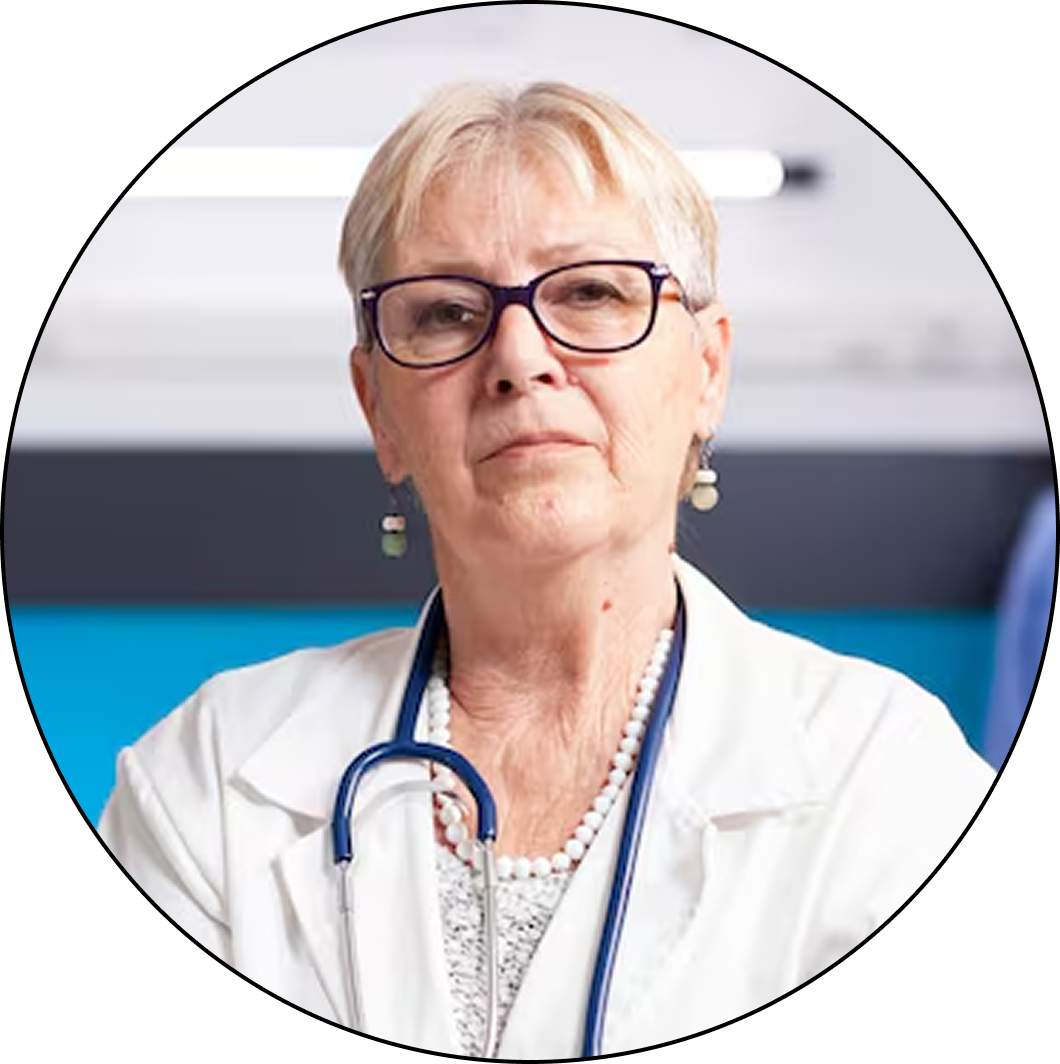 A headshot of a senior female doctor with glasses and a stethoscope looking toward the camera.