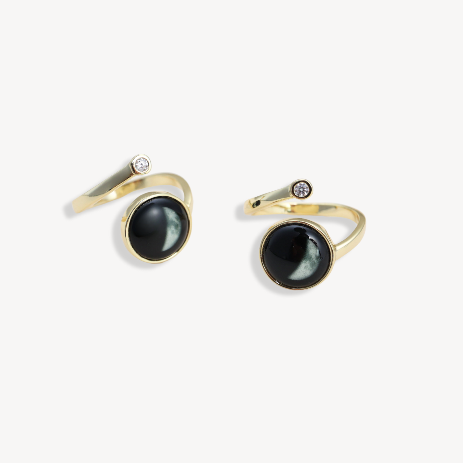 Gold rings with black stones and small diamond accents.