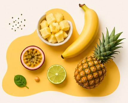An overhead shot of a banana, pineapple, passion fruit, lime, and a bowl of chopped pineapple.