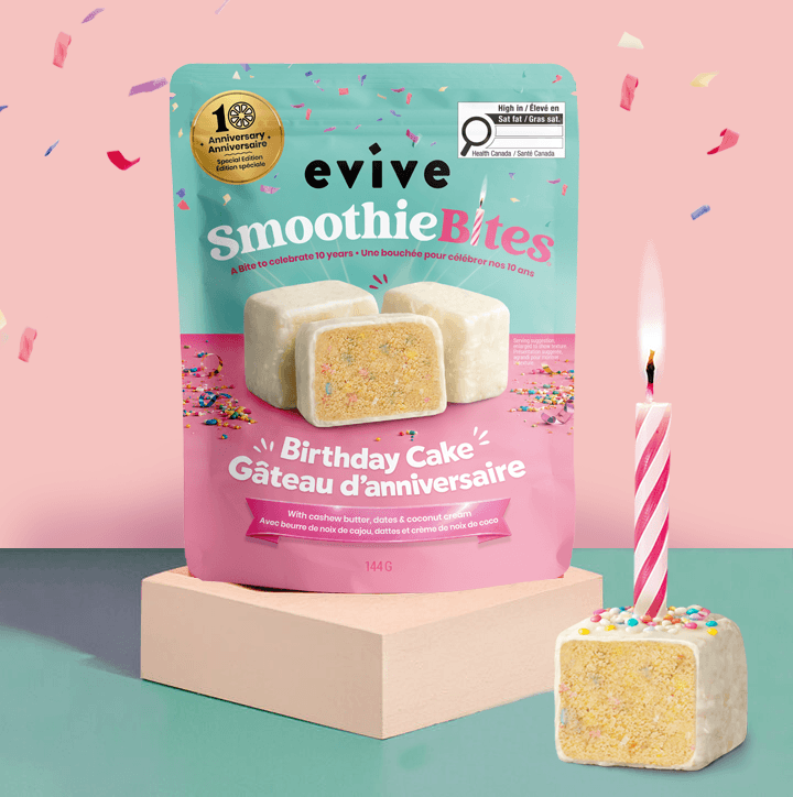 A bag of Evive Birthday Cake SmoothieBites next to a single bite with a lit birthday candle.