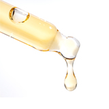 Close-up of a dropper releasing a drop of liquid.