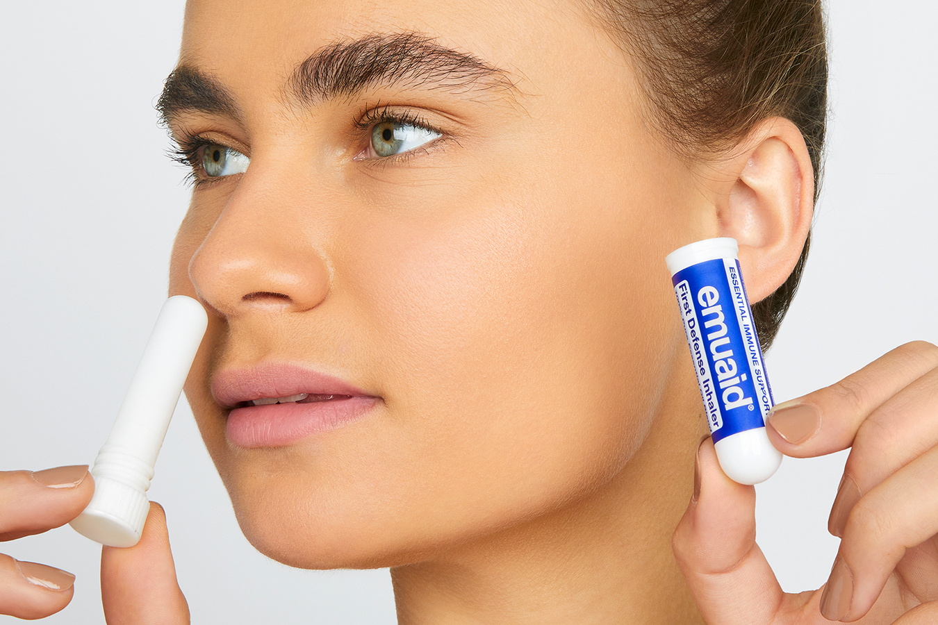 Frau, die den First Defense Inhalator benutzt 