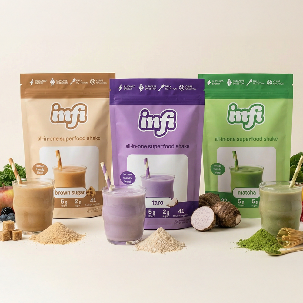 Packages of superfood shakes in brown, purple, and green with glasses and straws in foreground.