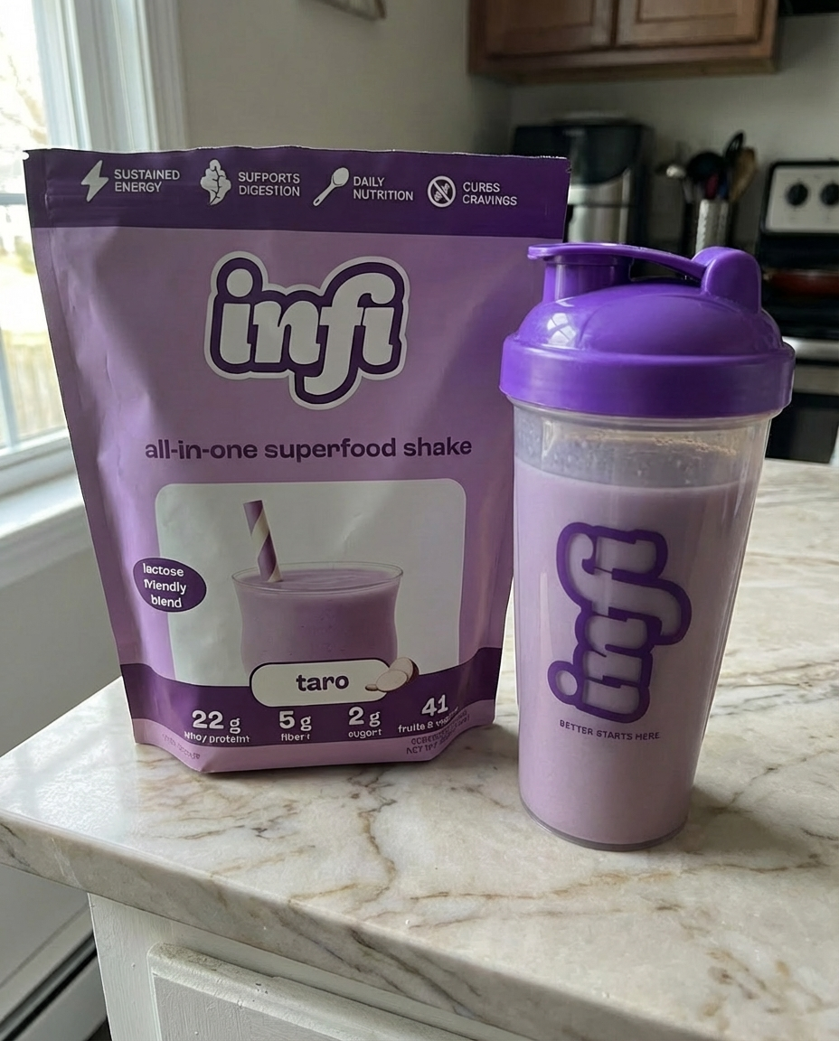 Purple superfood shake pack and blender bottle on kitchen counter.