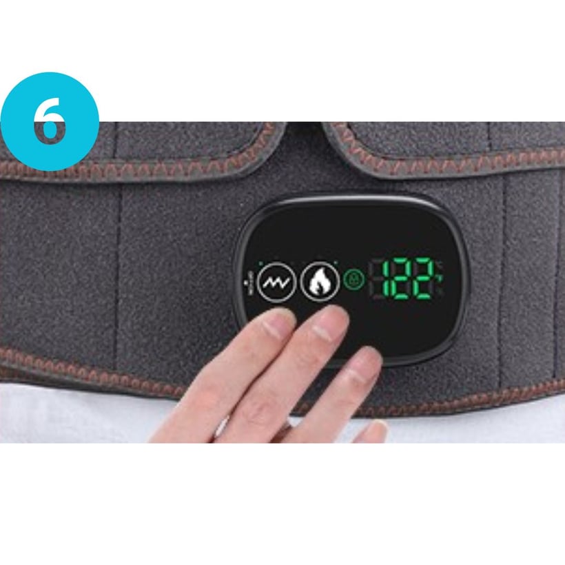 Hand adjusting settings on a digital control panel of a heating pad.