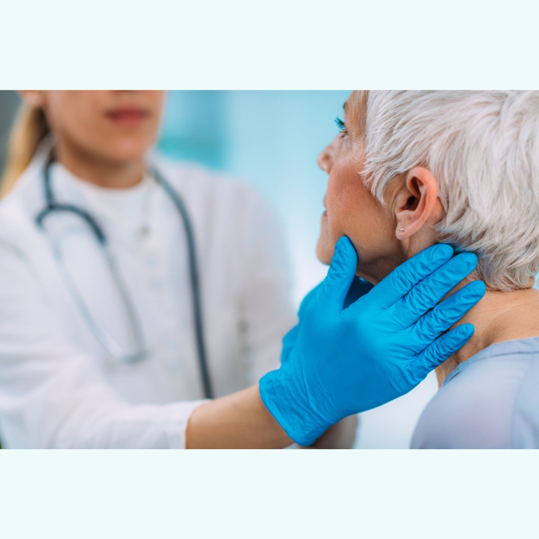 Doctor examining a patient's neck with blue gloves.