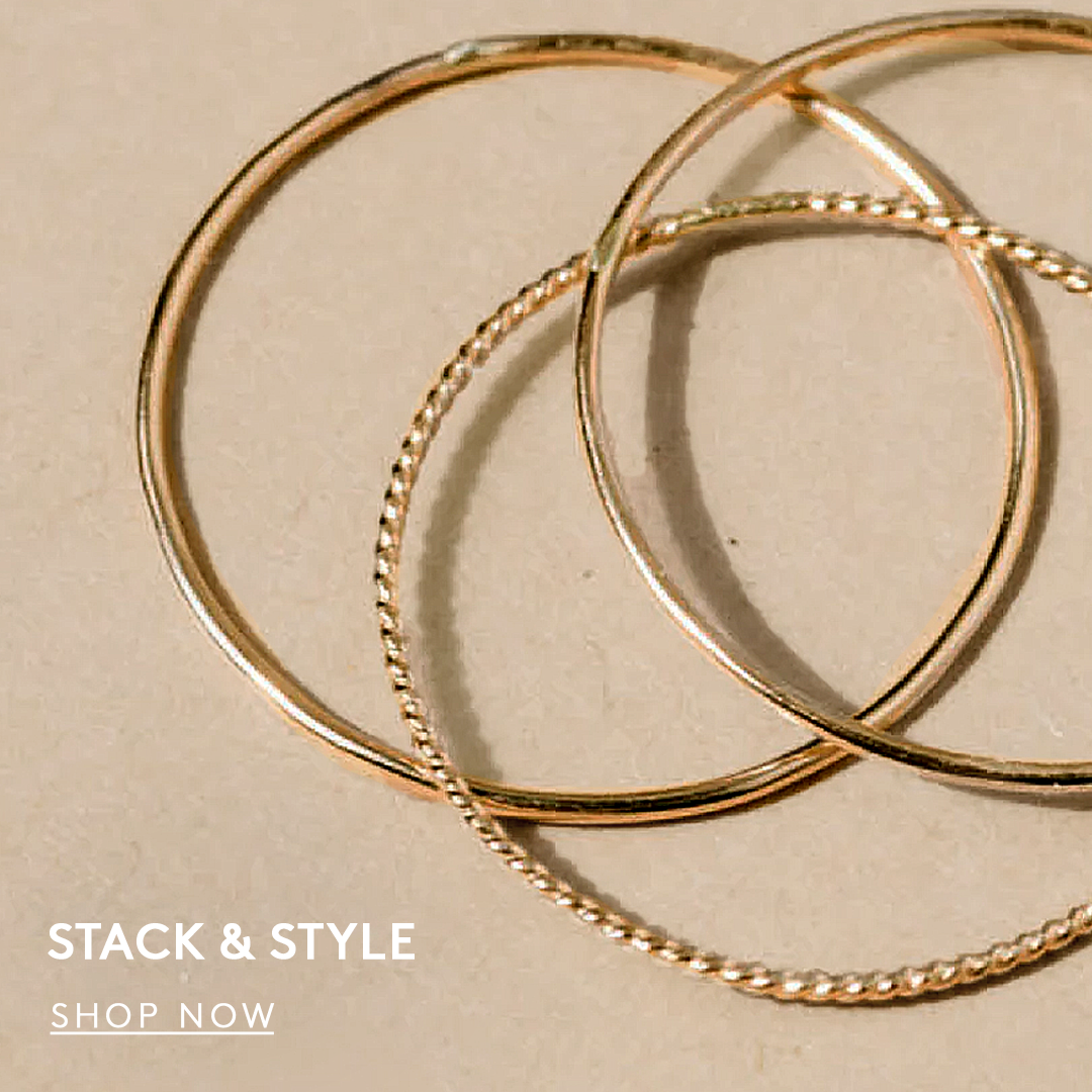 stack of a three ring set in gold, text reads stack and style, shop now