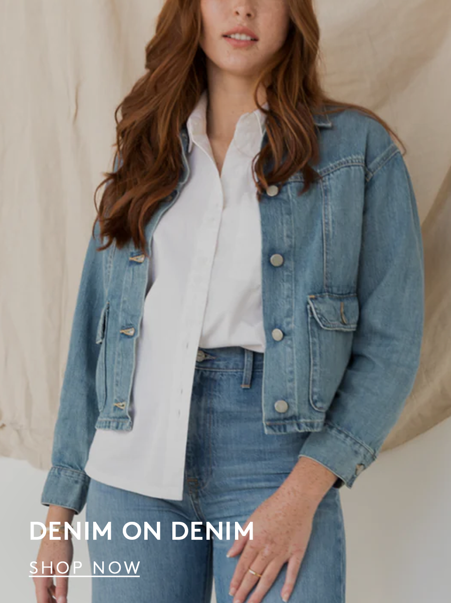 woman wearing a denim jacket over a white button down with jeans, text reads denim on denim, shop now