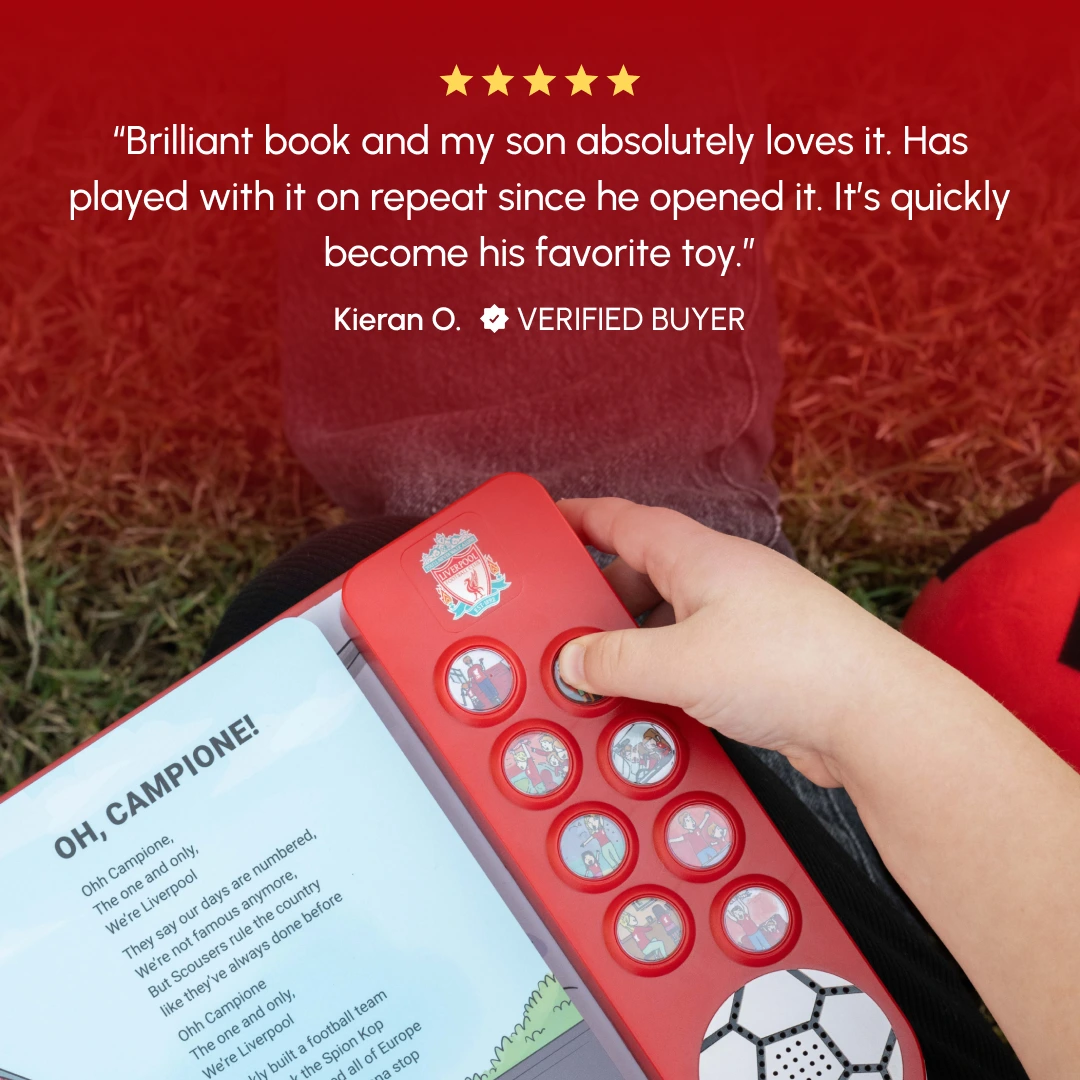 Child pressing buttons on a Liverpool-themed sound book outdoors.