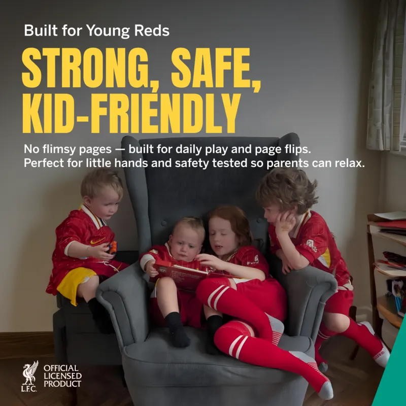 Four children in sports jerseys reading on a gray armchair.