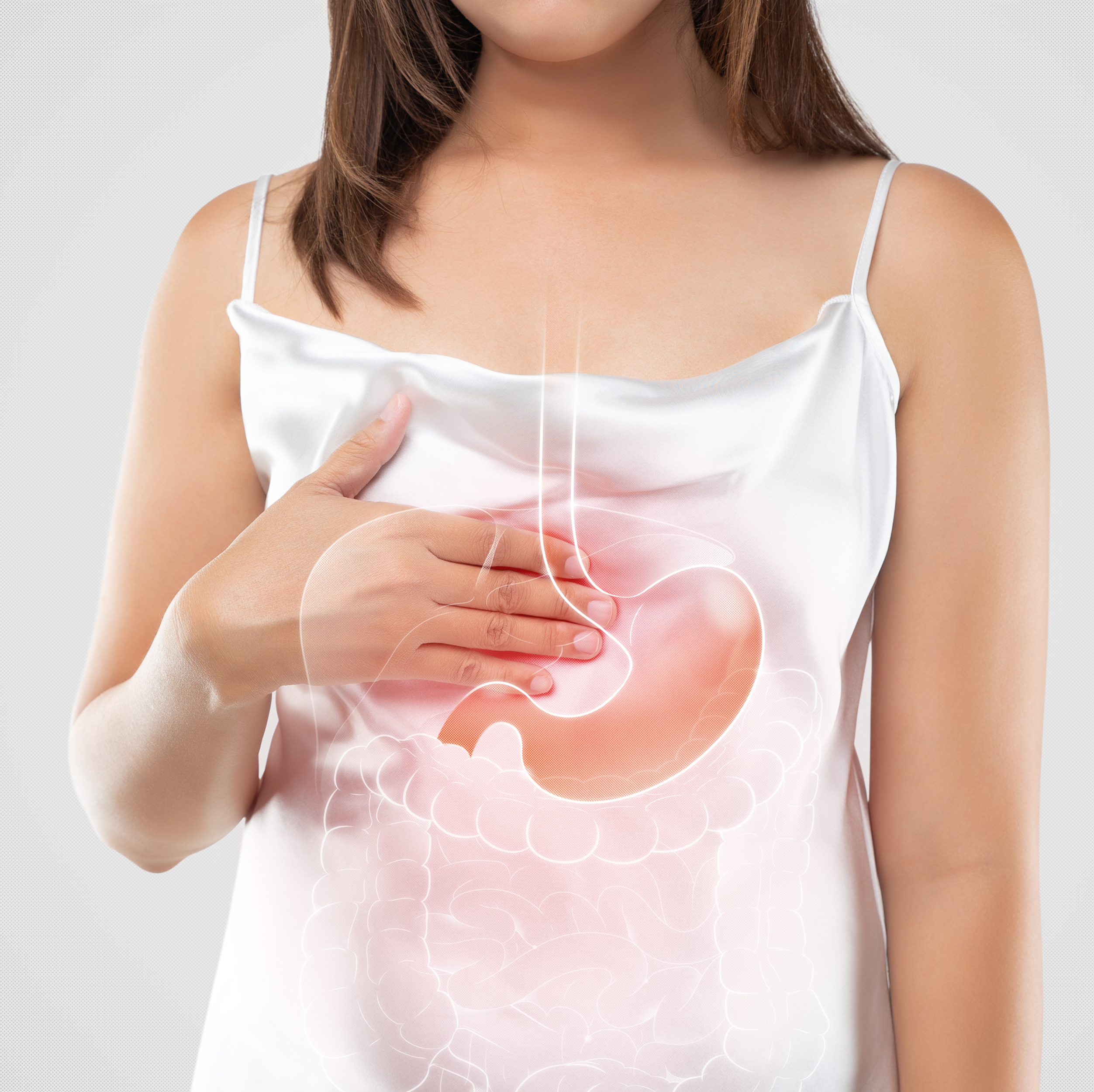Woman holding stomach with digestive system illustration overlay.