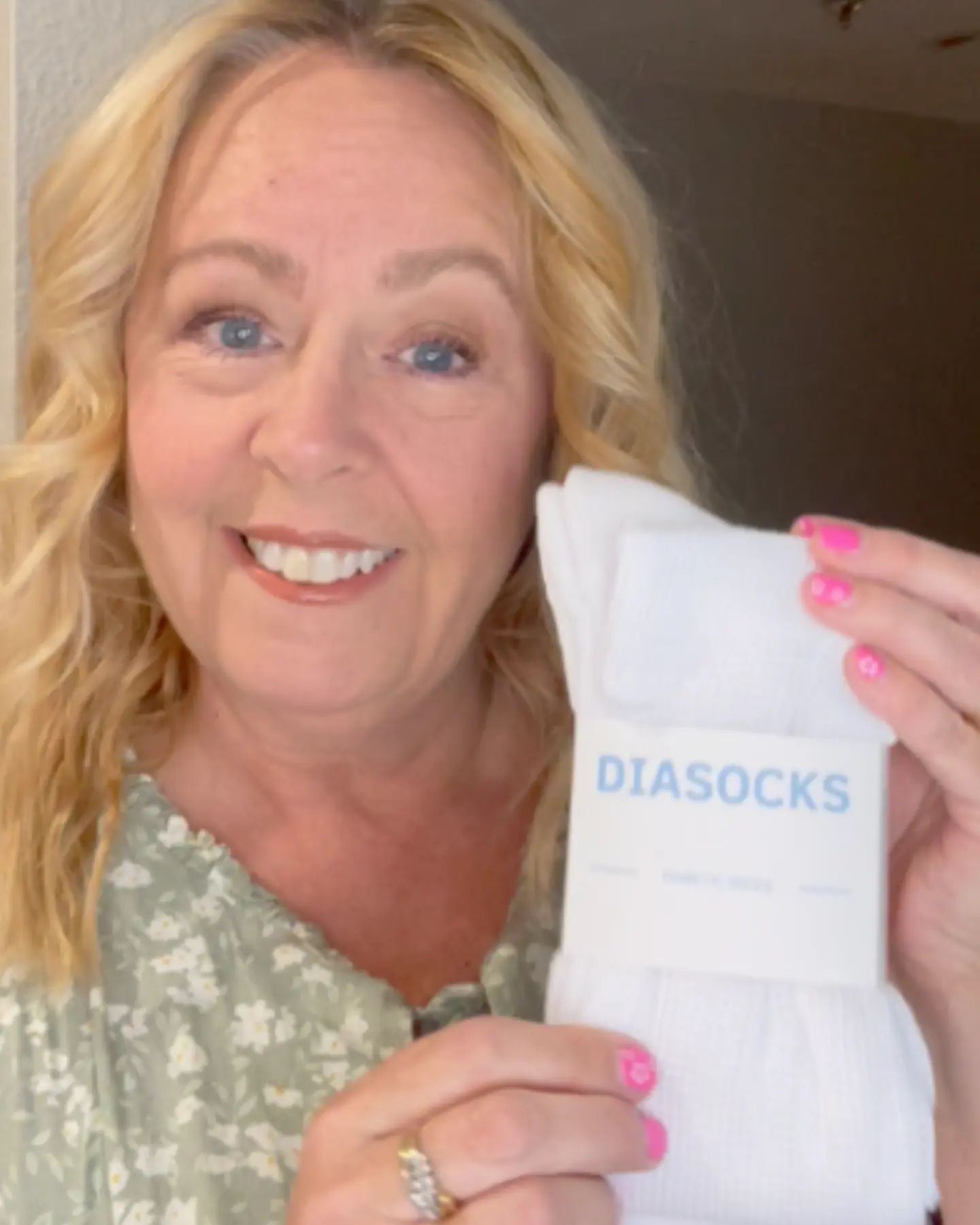 Person holding a package of white socks labeled 'Diasocks.'