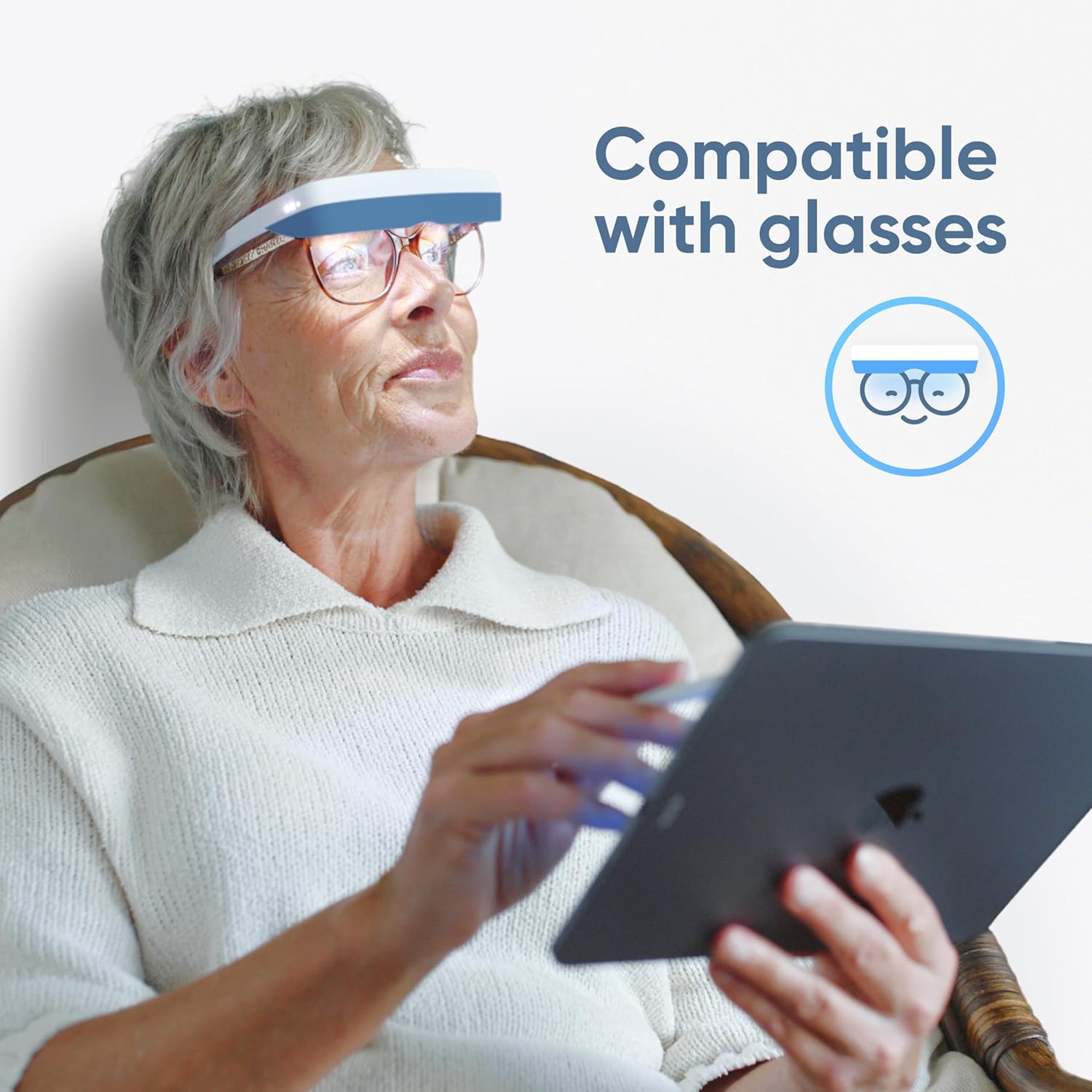 Person wearing a smart device on head, holding a tablet, with text 'Compatible with glasses'.