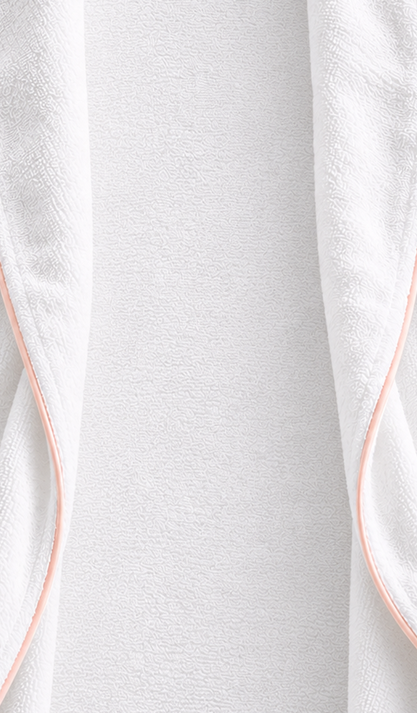 Close-up of white Egyptian cotton terry and blush cotton piping