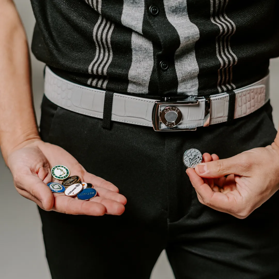 Person holding several poker chips in their hands.