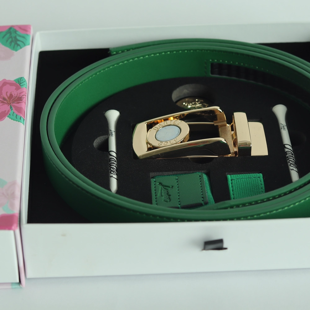 Green belt with gold buckle in a gift box with golf tees.