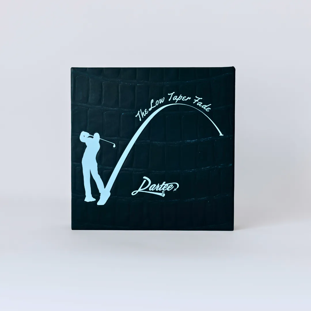 Black box with golfer silhouette and text 'The Low Taper Fade, Partee?'