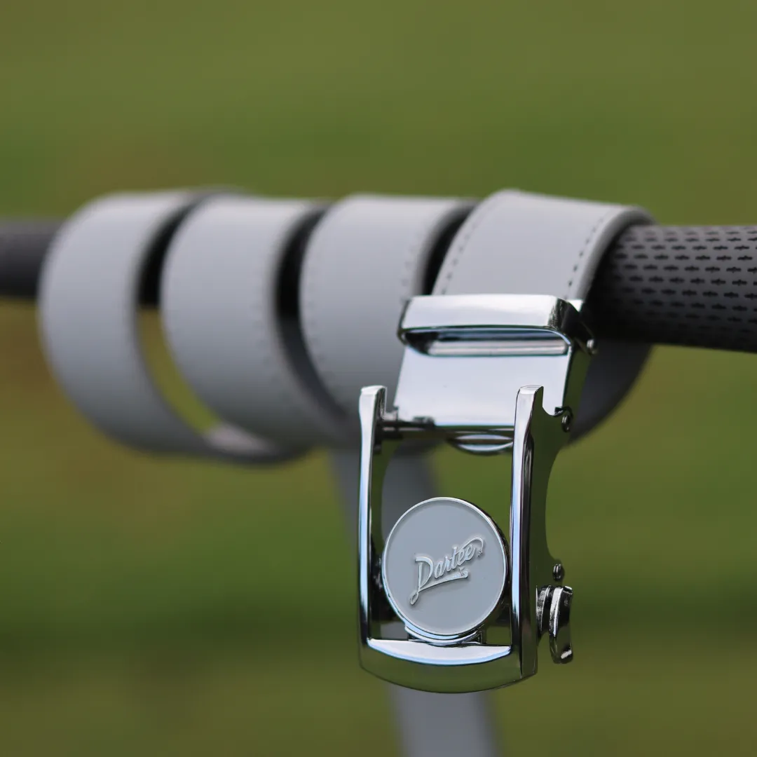 Close-up of a silver belt buckle on a gray strap.