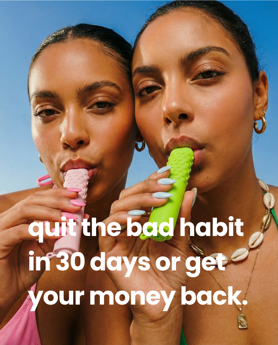 Two women hold pink and green textured objects to their mouths against a blue sky.