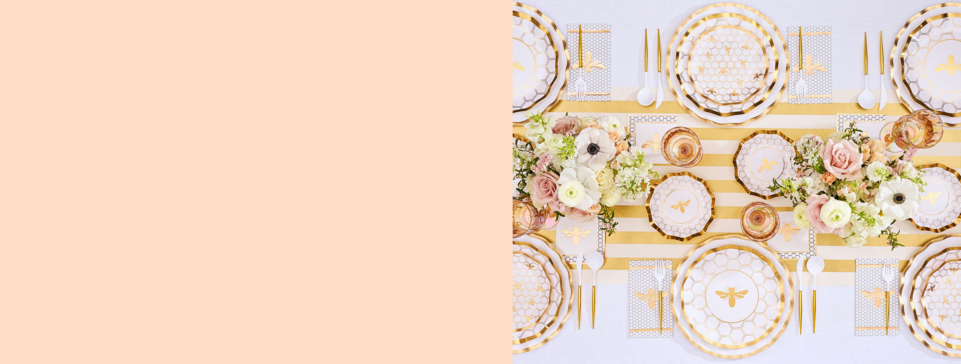 An overhead view of a bee-themed party tablescape with gold-rimmed plates, cutlery, and floral arrangements.