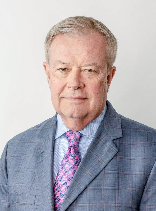 Man in a blue checkered suit and pink patterned tie.