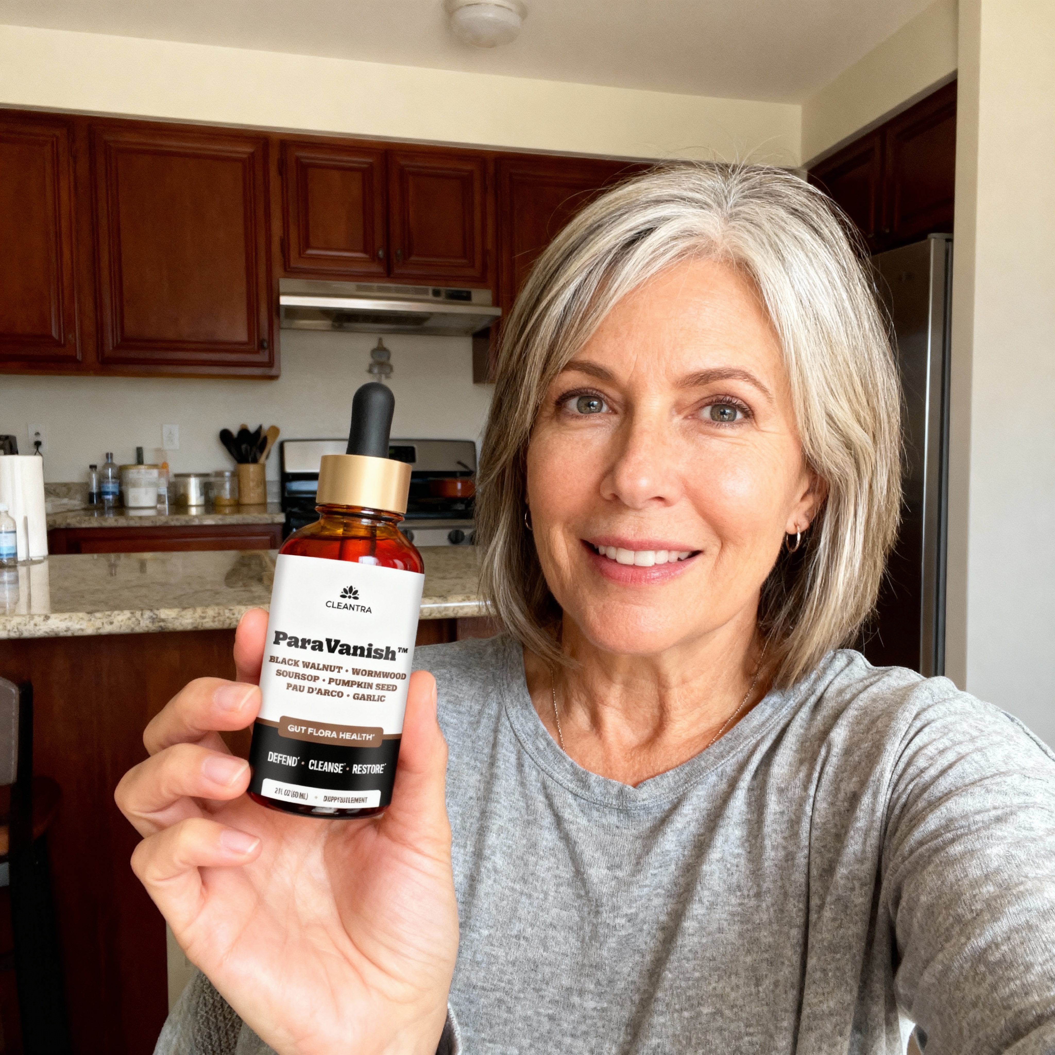 Person holding a bottle labeled 'ParaVanish' in a kitchen setting.
