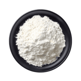 A black bowl filled with white flour on a white background.